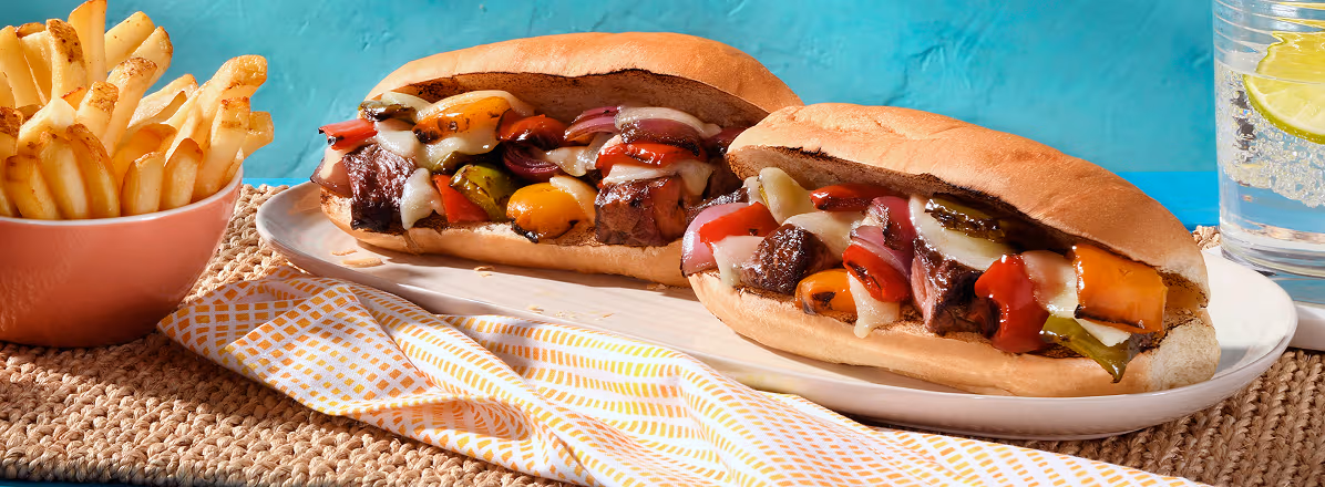 Two Philly Cheesesteak beef kabob sandwiches with side of fries