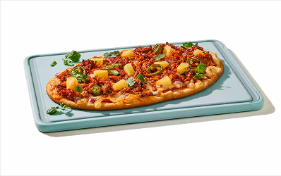 Flatbread pizza topped with al pastor pulled pork, pineapple, jalapenos, red onion and cilantro.
