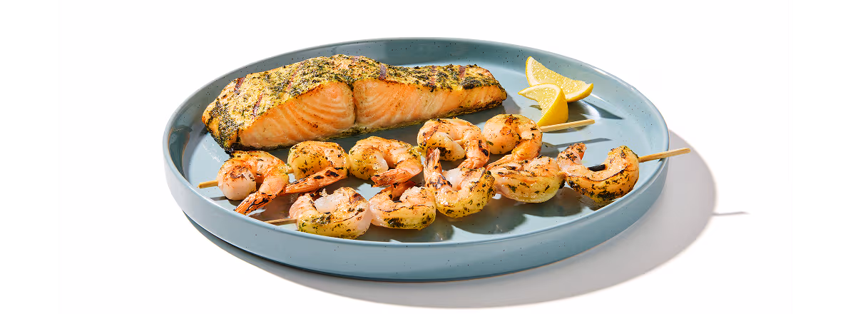 Plate of shrimp kabobs and salmon filet