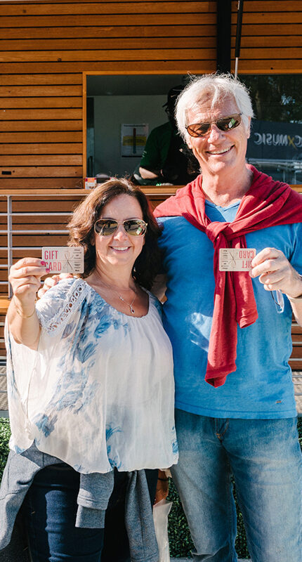 people holding Sobeys gift cards in front of Sobeys food truck