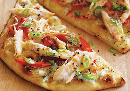 Chicken strips, veggies, and cheese–topped naan pizza.