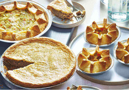 Golden baked chicken pot pies on table.