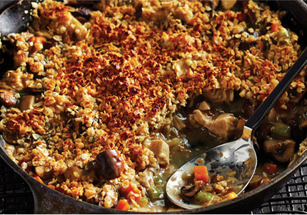Oat crumble–topped chicken pot pie cooked in cast iron skillet.