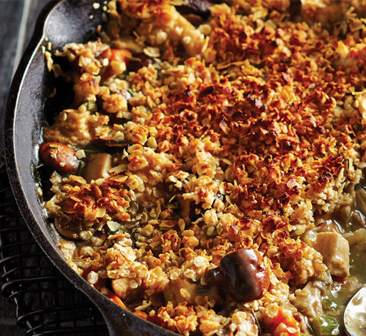 Oat crumble–topped chicken pot pie cooked in cast iron skillet.