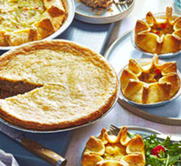 Golden baked chicken pot pies on table.