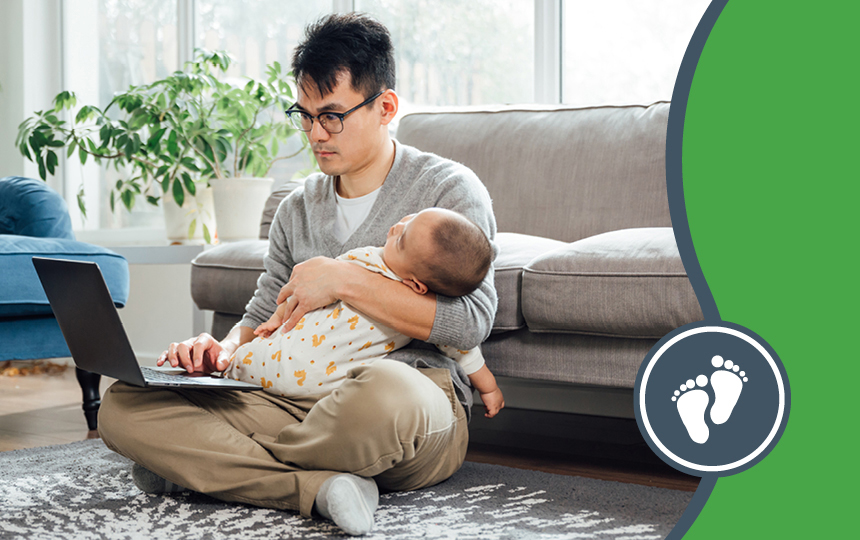 baby-keep-us-close Parent holding baby while typing on a laptop