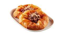 butter-danish-coffee-crisp Two round Danishes filled with Coffee Crisp spread and crumbs on a white plate.