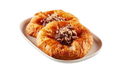 Two round Danishes filled with Coffee Crisp spread and crumbs on a white plate.