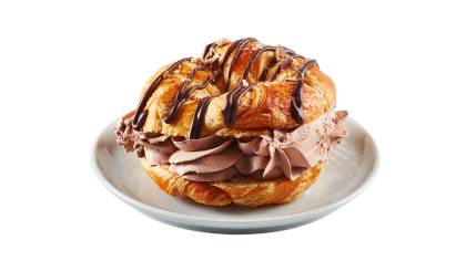 croissants_coffee_crisp Close up of croissant filled with Coffee Crisp spread drizzled in fudge sauce with candy bar pieces on white plate.