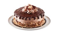 dessert-cake-coffee-crisp Layered cake iced with a fudge topped pour-over effect, finished with candy bar pieces on a white plate.