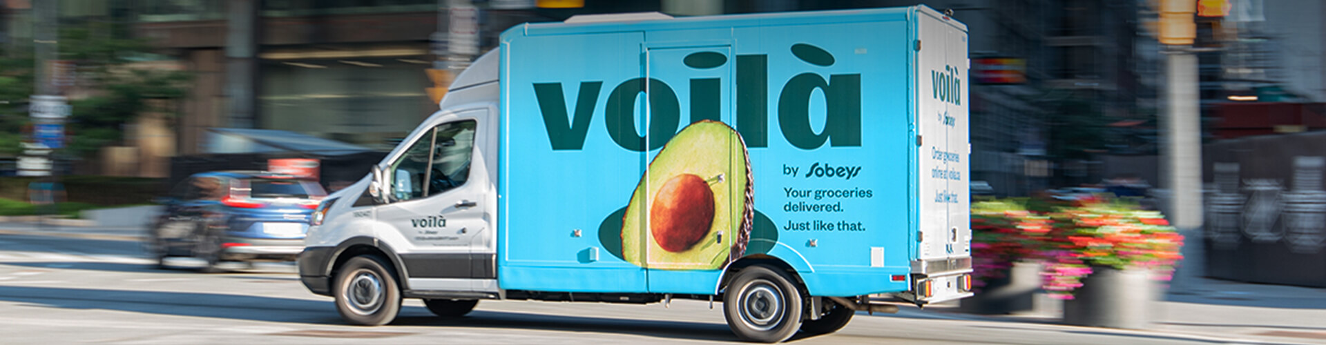 Picture of a delivery truck of Voila with the text written 'Voila by Sobeys. Your groceries delivered. Just like that.'