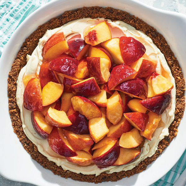 Slices of fresh peach over a cream cheese filling and cookie crust.