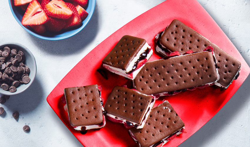 Compliments chocolate ice cream sandwiches filled with sliced strawberries