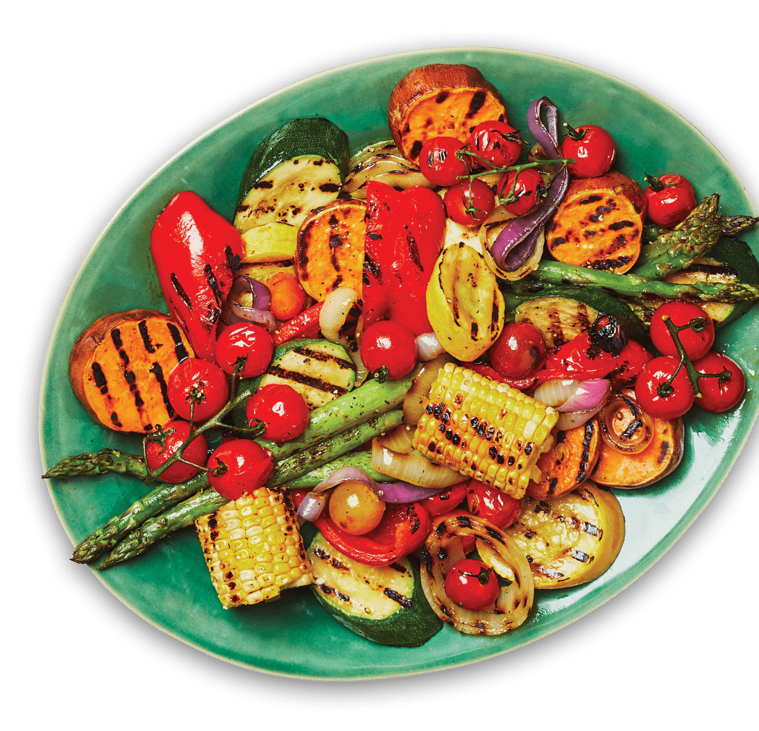 Various grilled vegetables, including asparagus, corn, and zucchini, on a green platter.