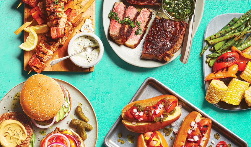 Last_summers_grilling_image A variety of grilled meats including burgers and hot dogs on a blue background.