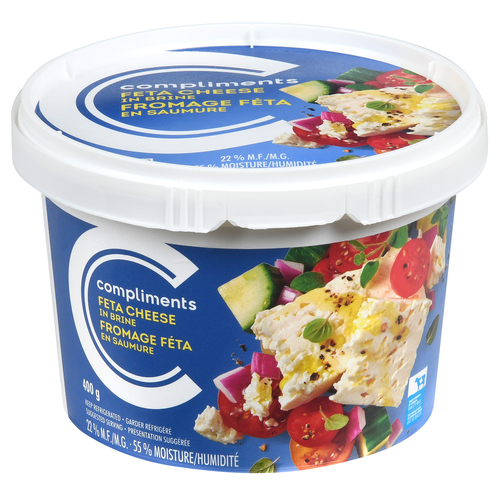 White tub of Compliments feta cheese with image of feta cubes and olives on front label.