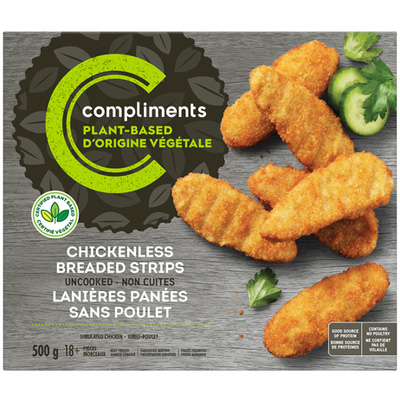 A grey cardboard box of Compliments Plant-Based Chickenless Breaded Strips, with some strips cooked and presented on the front of the box with sliced fresh cucumber on the side.