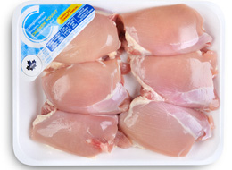 Value package of chicken thighs in a tray with a blue Compliments label.