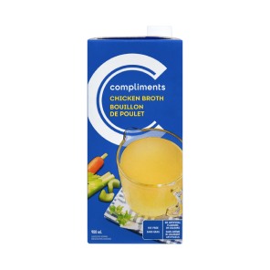 Blue tetra Pak of Compliments Chicken Broth with a measuring cup image on the front full of broth.