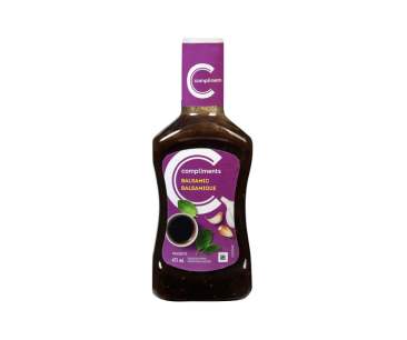  Clear bottle of Compliments Balsamic Vinaigrette with a purple sticker with image of garlic, balsamic vinegar and herbs.  
