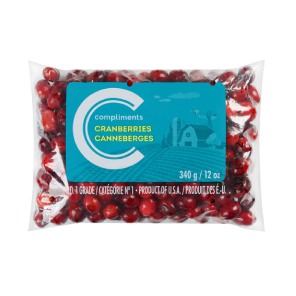 Clear plastic bag of Compliments fresh cranberries with a blue illustration of a farmhouse.