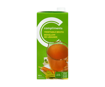 Green tetra pack of Compliments Vegetable broth showing a measuring cup full of broth.

 