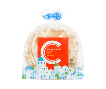 Clear bag of Compliments white pita breads with an illustration of Greek island homes.
