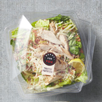 Prepared Chicken Caesar, Ready For You Salad in a plastic to-go container. 