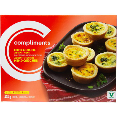 Red Compliments Mini Quiche Assortment box with photo of nine mini quiches atop a black plate atop a red towel.
