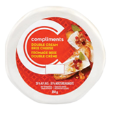 Wheel of Compliments double cream brie in white package with red label.
