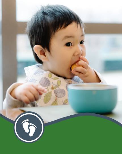 Child feeding themselves at a table