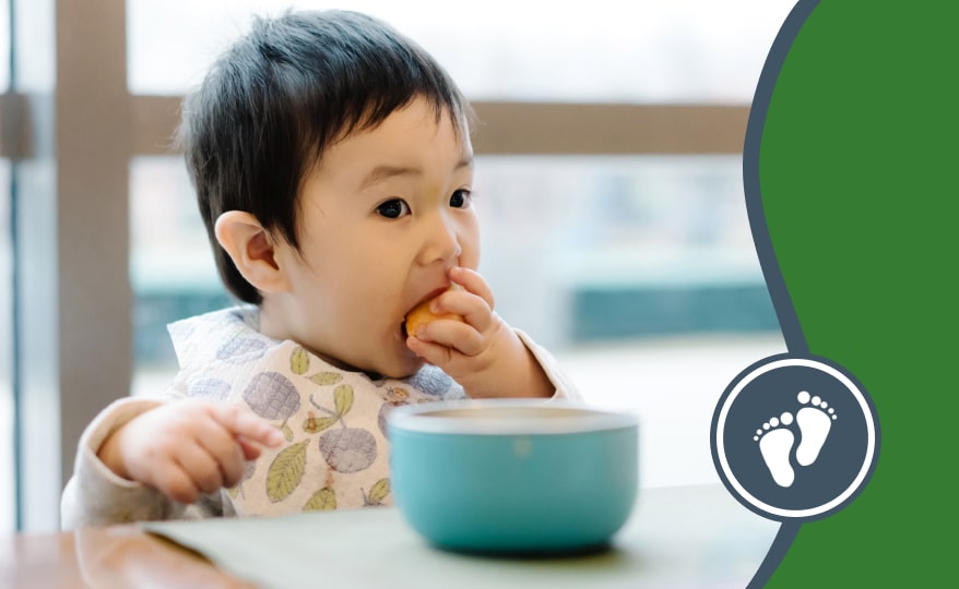 Child feeding themselves at a table