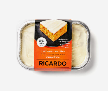 Metallic sheet pan filled with Carrot Cake with an orange cardboard wrapper.