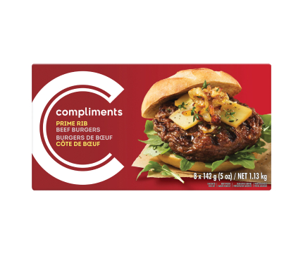 A burgundy box of Compliments Prime Rib Beef Burgers with a photograph of a dressed burger on the front of the package.