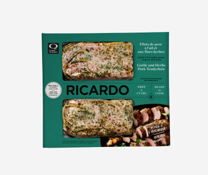 Teal cardboard packaging with two portions of Cryovac-wrapped Garlic and Herbs Pork Tenderloin peering through the teal windows.