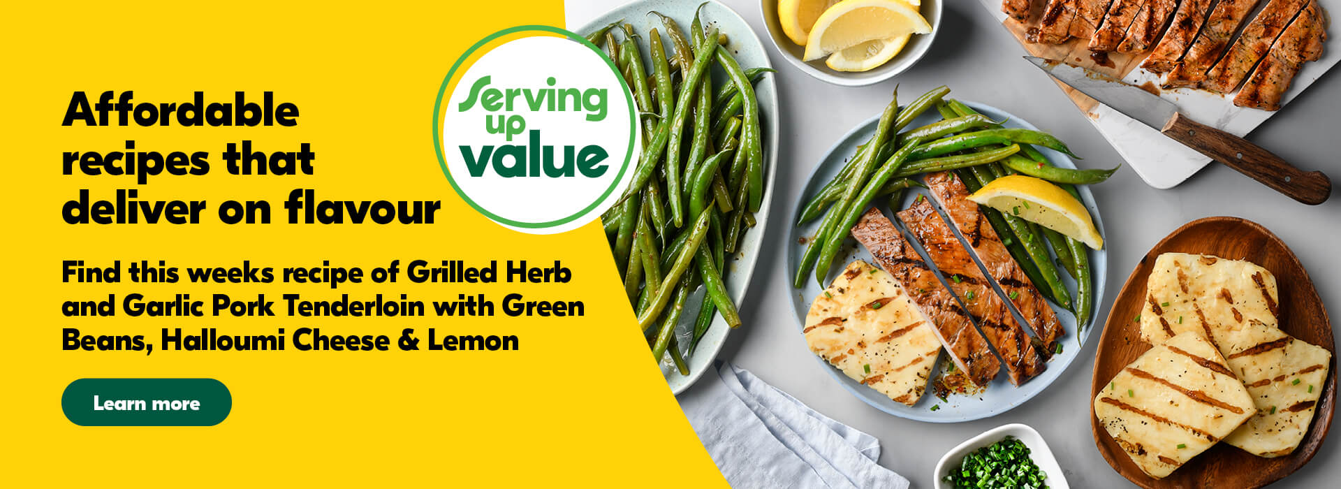 White plate with sliced pork tenderloin, green beans, halloumi cheese, 1/4 of a lemon, topped with diced chives. Surrounded by a plate of green beans, bowl with quartered lemon, plate with sliced pork tenderloin, plate with halloumi cheese, and a bowl with diced chives.