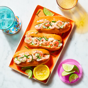 Orange rectangular platter topped with Chive-Lime Shrimp rolls.