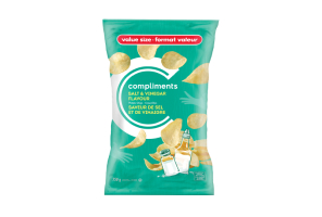 A pale green packet of Compliments Salt & Vinegar Flavour Potato Chips with an illustration of a vinegar bottle and a salt shaker on the front.