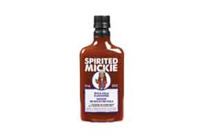 Mickey-style bottle with an illustration of a woman holding a rye & coke cocktail on the front with a two-chili rating on the heat level.