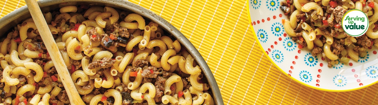 bowl of beef and macaroni on yellow placemat