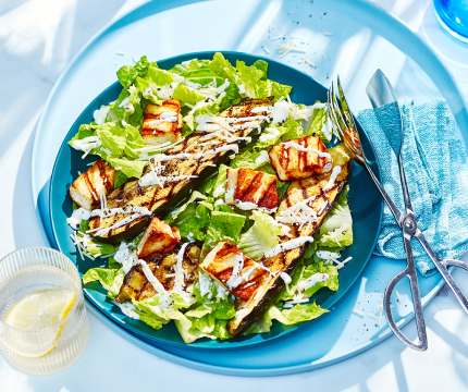 Large serving platter with grilled zucchini strips, romaine lettuce, halloumi croutons and caesar dressing