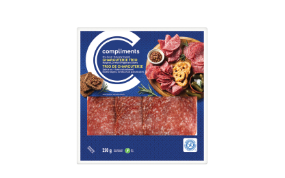Clear plastic package of Compliments Charcuterie Trio (Hungarian, Cervelat and Peppercorn) with blue label.