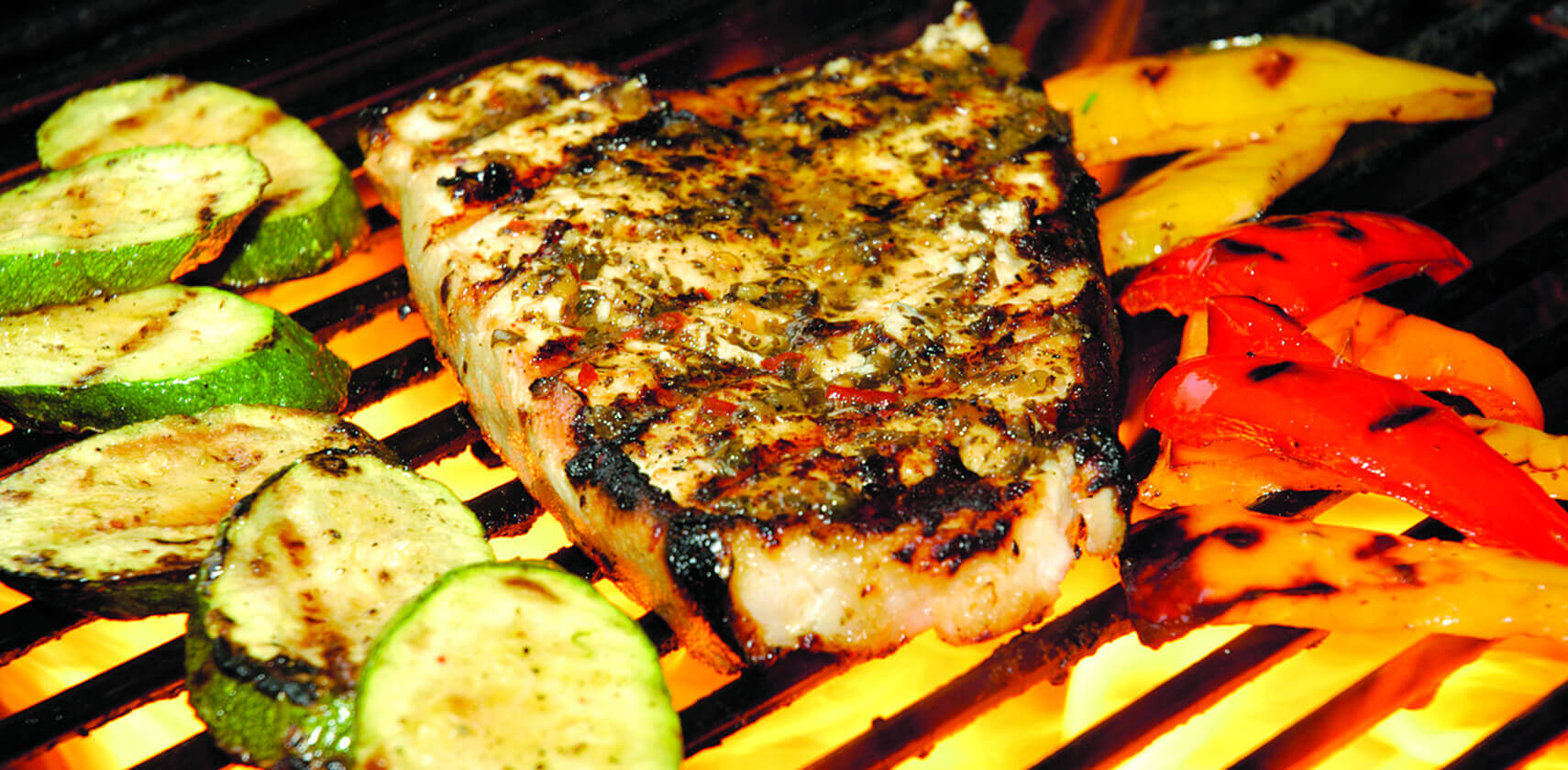 Halibut and vegetables grilling on the barbecue