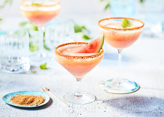 Three watermelon beergaritas in margarita glasses.