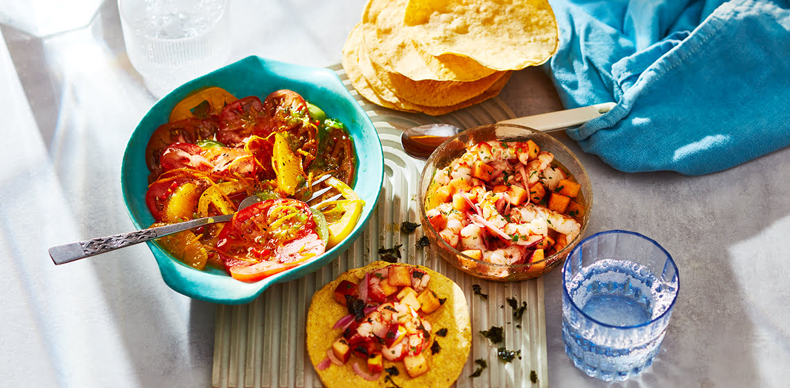 Teal bowl of Heirloom Tomato Ceviches with a fork in it.