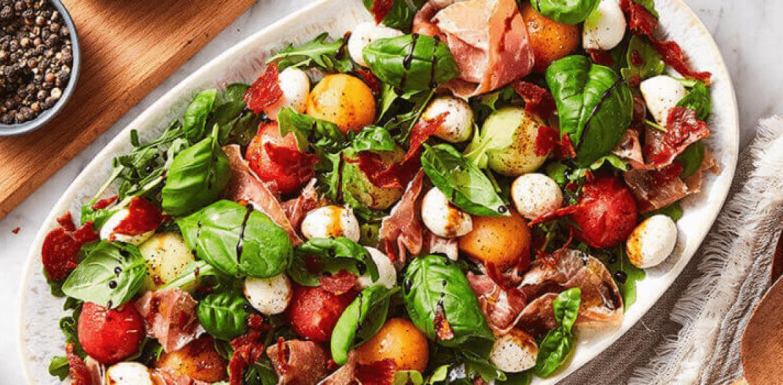 Bowl of melon and prosciutto summer salad