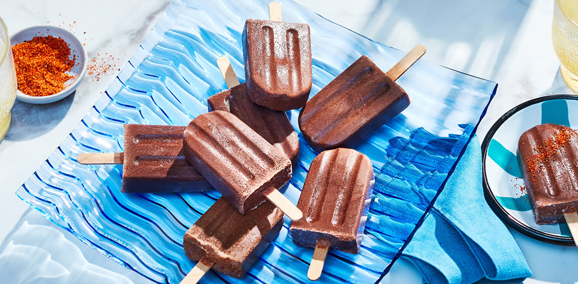 Blue platter of Mexican-inspired Chocolate Ice Pops with tajin spice