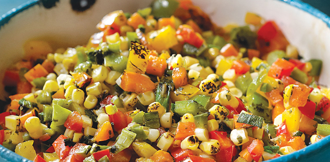 Blue bowl filled with Roasted Corn Relish.