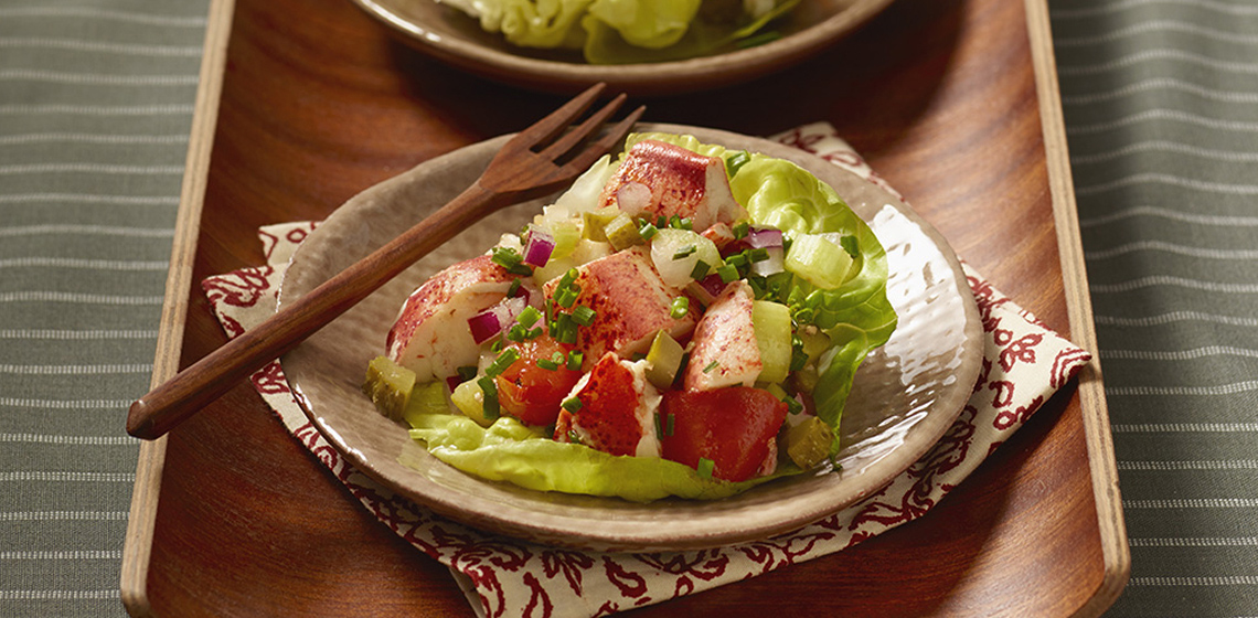 Two smaller plates with Spicy Caesar Lettuce Rolls including wooden fork.