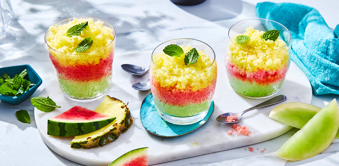Three glasses of multi-coloured melon Tropical Fruit Granitas
